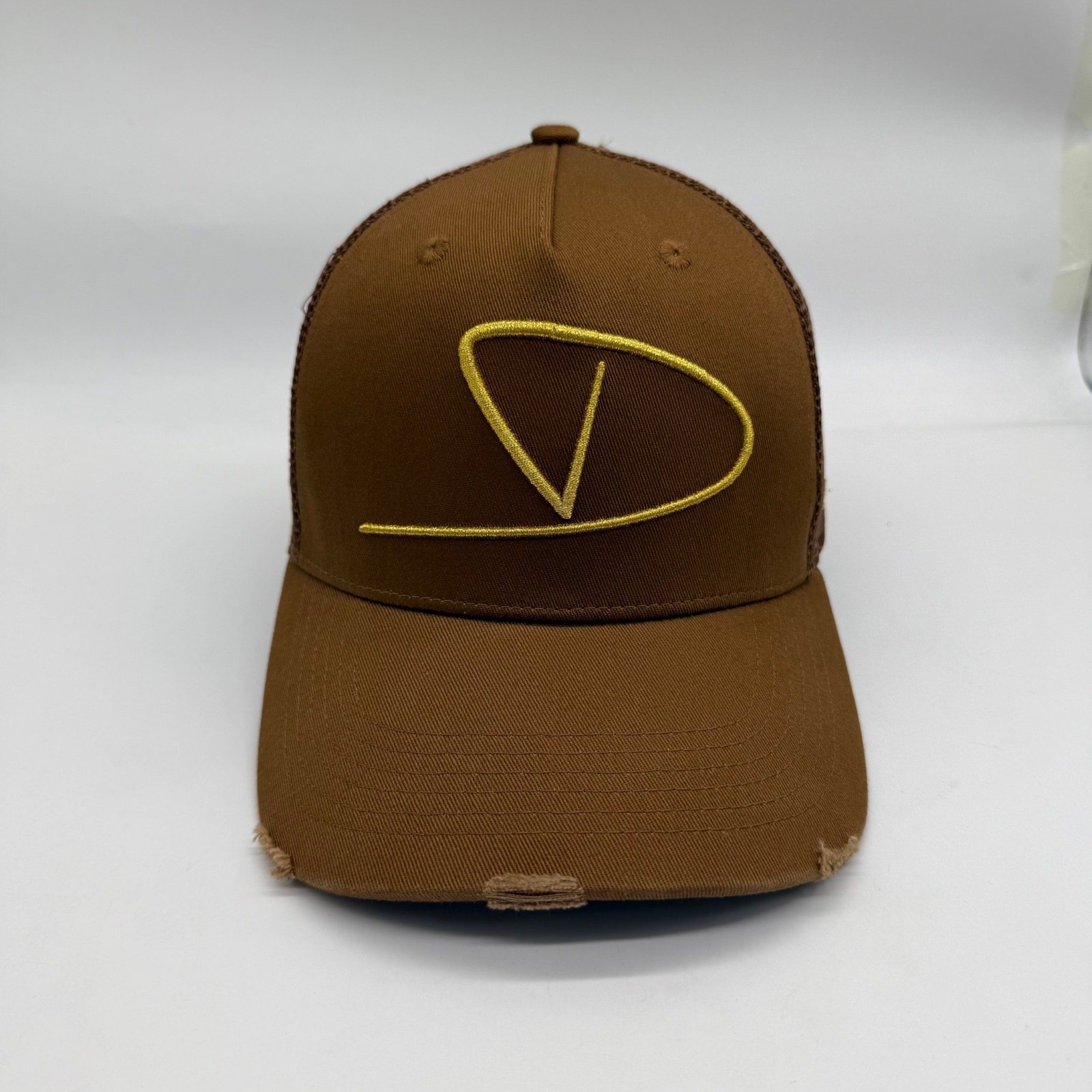 Cognac tan Dinero trucker cap front with metallic gold D monogram